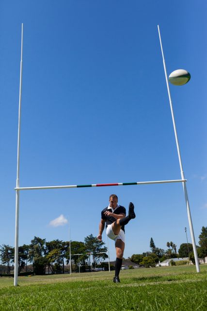 Rugby player kicking ball through goal post - Download Free Stock Photos Pikwizard.com