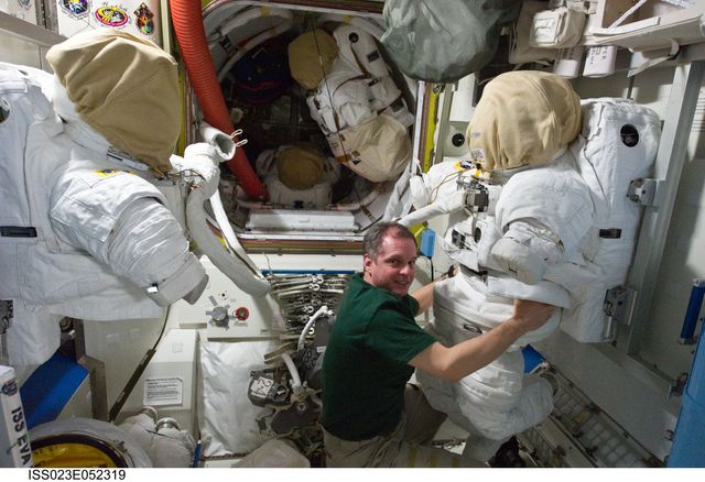 ISS023-E-052319 (26 May 2010) --- NASA astronaut T.J. Creamer, Expedition 23 flight engineer, works with an Extravehicular Mobility Unit (EMU) spacesuit in the Quest airlock of the International Space Station.