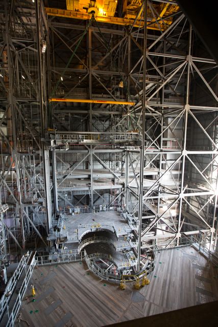 High up in the Vehicle Assembly Building (VAB) at NASA's Kennedy Space Center in Florida, a crane lowers the second half of the B-level work platforms, B north, for NASA's Space Launch System (SLS) rocket, for installation in High Bay 3. The B platform will be installed on the north side of high bay. The B platforms are the ninth of 10 levels of work platforms that will surround and provide access to the SLS rocket and Orion spacecraft for Exploration Mission 1. The Ground Systems Development and Operations Program is overseeing upgrades and modifications to VAB High Bay 3, including installation of the new work platforms, to prepare for NASA’s Journey to Mars. 