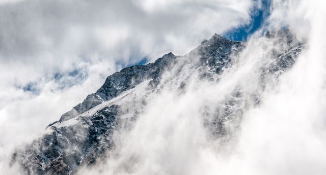 a mountain covered in clouds - Download Free Stock Photos Pikwizard.com