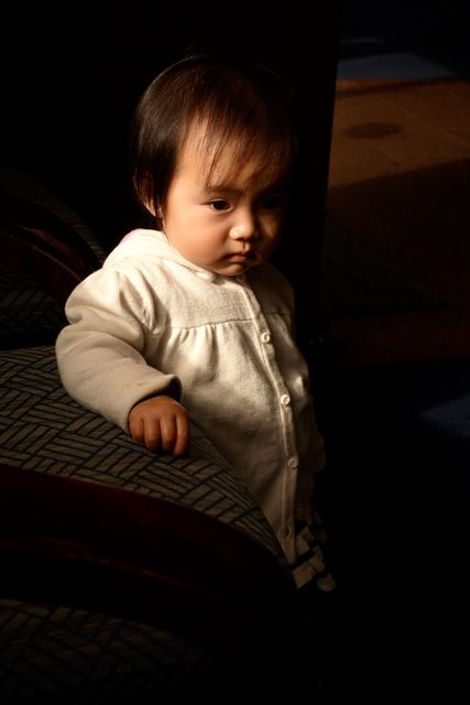 a baby sitting on a chair - Download Free Stock Photos Pikwizard.com