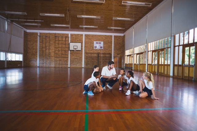 Sports teacher having discussion with his students - Download Free Stock Photos Pikwizard.com