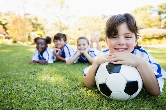 Close up view of girl lying on the floor with her soccer team- Download Free Stock Photos Pikwizard.com