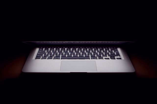 View of laptop against black background. Gadget and modern technology concept