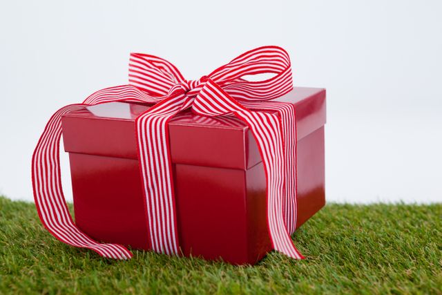 Red gift box on green grass - Download Free Stock Photos Pikwizard.com