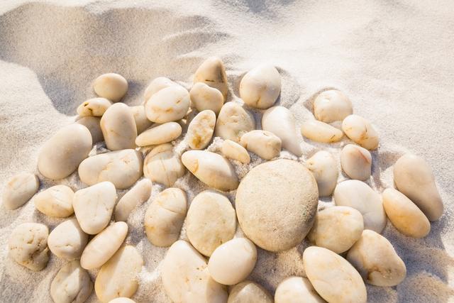 Close-up of white pebbles on sand surface - Download Free Stock Photos Pikwizard.com