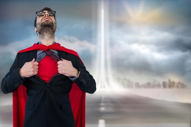 Businessman in super hero costume tearing shirt against cloudy sky - Download Free Stock Photos Pikwizard.com