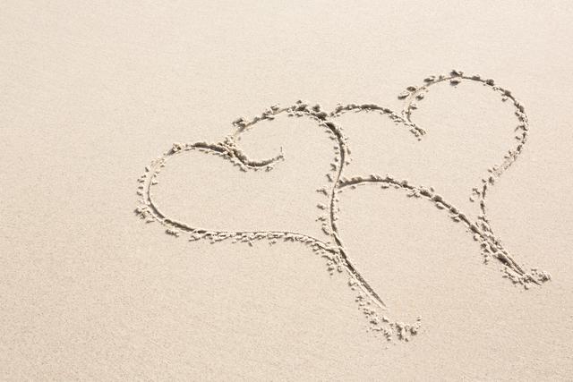Two heart shapes drawn on sand - Download Free Stock Photos Pikwizard.com