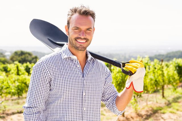 Portrait of man holding shovel at vineyard - Download Free Stock Photos Pikwizard.com