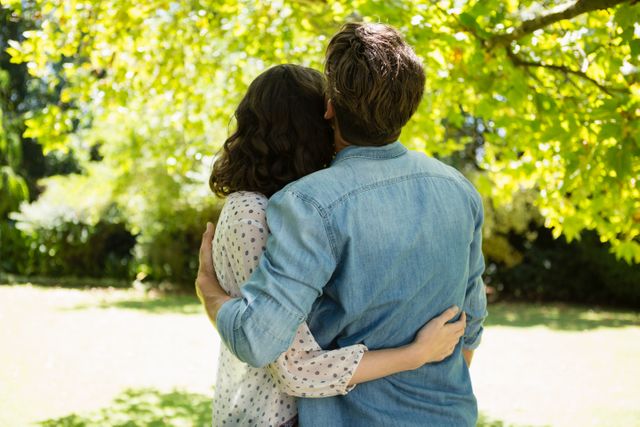 Couple embracing each other in garden on a sunny day - Download Free Stock Photos Pikwizard.com