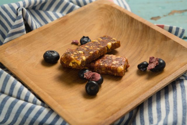 Granola bar and blueberry on wooden plate - Download Free Stock Photos Pikwizard.com