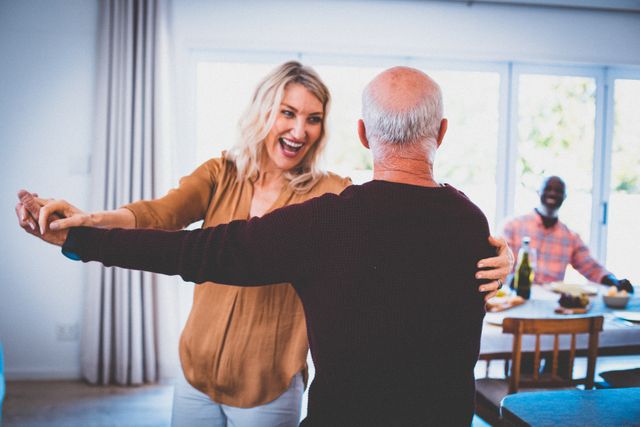 Senior caucasian woman and man having fun dancing at home with diverse group of friends - Download Free Stock Photos Pikwizard.com