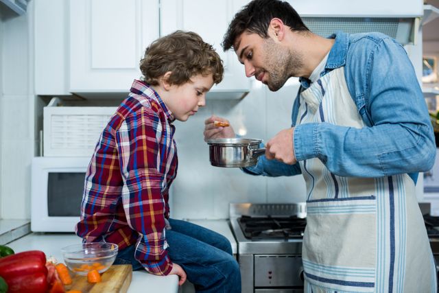 Father and son cooking food together - Download Free Stock Photos Pikwizard.com