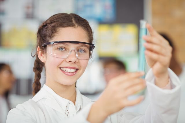 Portrait of schoolgirl doing a chemical experiment in laboratory - Download Free Stock Photos Pikwizard.com