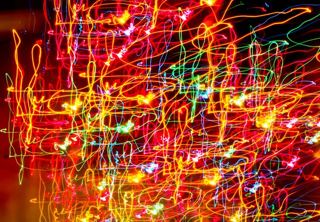  doodles of Colorful light trails against black background. Background with abstract texture and design concept