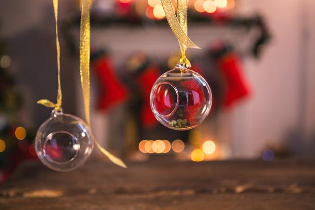 Close-up of christmas ornaments hanging on ribbon at home
