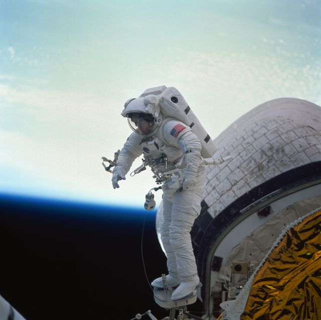 Astronaut James Newman during in-space evaluation of portable foot restraint - Download Free Stock Photos Pikwizard.com