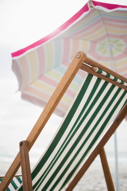 Empty beach chair and parasol - Download Free Stock Photos Pikwizard.com