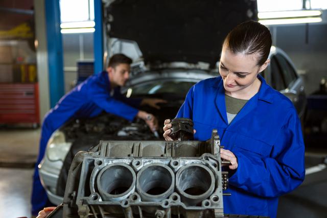 Female mechanic working on engine - Download Free Stock Photos Pikwizard.com