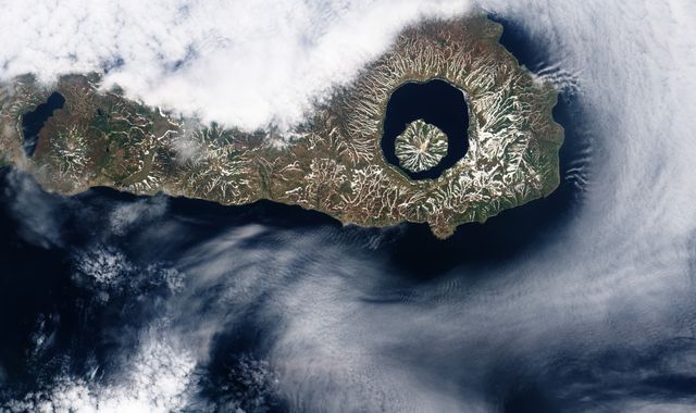More than 9,000 years ago, a catastrophic volcanic eruption created a huge caldera on the southern end of Onekotan Island, one of the Kuril Islands, located off the southern tip of Russia’s Kamchatka Peninsula. Today, the ancient Tao-Rusyr Caldera is filled by the deep blue waters of Kal’tsevoe Lake.  The Advanced Land Imager (ALI) on NASA’s Earth Observing-1 (EO-1) satellite acquired this true-color image of southern Onekotan on June 10, 2009. In this late-spring shot, snow or ice lingers on the land, forming white streaks on a brown-and-green land surface. In the northwest quadrant of the caldera is Krenitzyn Peak, which rises to a height of 1,325 meters (4,347 feet).  Like the other Kuril Islands, Onekotan lies along the Pacific “Ring of Fire.” The Kuril Island volcanoes are fueled by magma generated by the subduction of the Pacific Plate under the Eurasian Plate, which takes place along a deep trench about 200 kilometers (120 miles) to the islands’ east. The only historical eruption at Krenitzyn Peak occurred in 1952, a week after a magnitude 9.0 earthquake along the subduction fault.  NASA Earth Observatory image created by Robert Simmon, using EO-1 ALI data provided courtesy of the NASA EO-1 team. Caption by Michon Scott and Rebecca Lindsey.   <b><a href="http://www.nasa.gov/audience/formedia/features/MP_Photo_Guidelines.html" rel="nofollow">NASA image use policy.</a></b>  <b><a href="http://www.nasa.gov/centers/goddard/home/index.html" rel="nofollow">NASA Goddard Space Flight Center</a></b> enables NASA’s mission through four scientific endeavors: Earth Science, Heliophysics, Solar System Exploration, and Astrophysics. Goddard plays a leading role in NASA’s accomplishments by contributing compelling scientific knowledge to advance the Agency’s mission.  <b>Follow us on <a href="http://twitter.com/NASAGoddardPix" rel="nofollow">Twitter</a></b>  <b>Like us on <a href="http://www.facebook.com/pages/Greenbelt-MD/NASA-Goddard/395013845897?ref=tsd" rel="nofollow">Facebook</a></b>  <b>Find us on <a href="http://instagrid.me/nasagoddard/?vm=grid" rel="nofollow">Instagram</a></b>