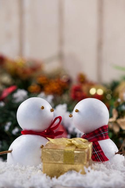 Two snowman with christmas gift - Download Free Stock Photos Pikwizard.com