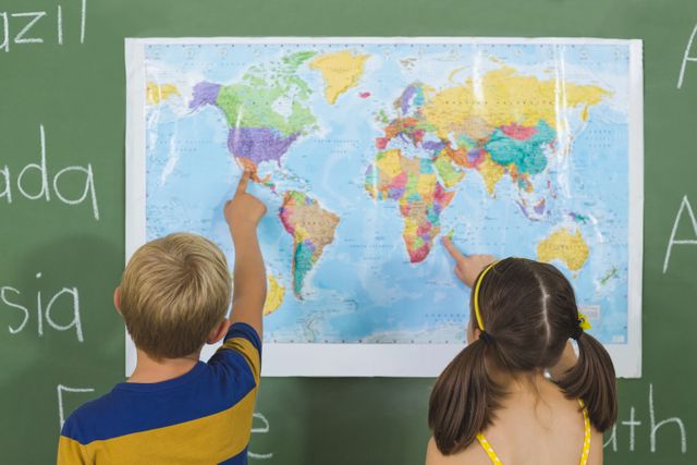 School kids pointing at map in classroom - Download Free Stock Photos Pikwizard.com