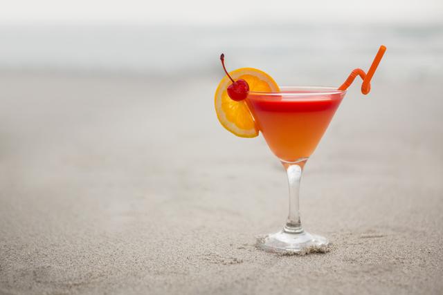 Glass of cocktail drink kept on sand - Download Free Stock Photos Pikwizard.com