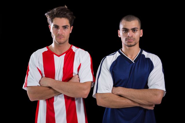 Two football players standing with arms crossed - Download Free Stock Photos Pikwizard.com