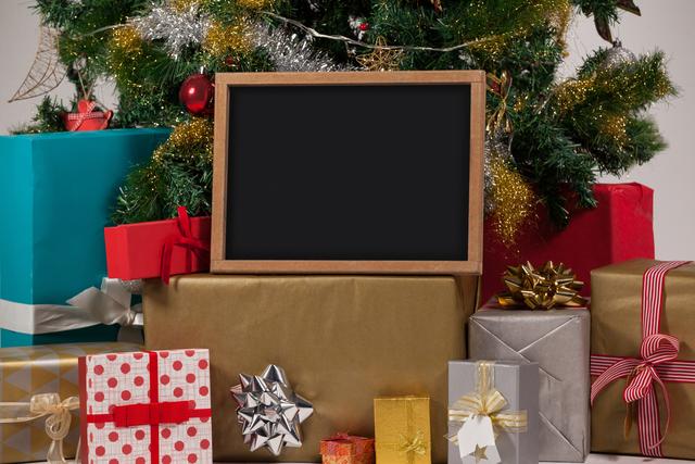 Blank slate with presents and christmas tree - Download Free Stock Photos Pikwizard.com