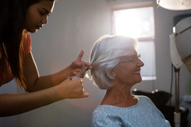 Hairsylist cutting hair of senior woman - Download Free Stock Photos Pikwizard.com