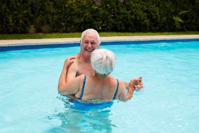 Senior couple dancing in the pool - Download Free Stock Photos Pikwizard.com