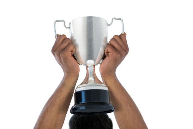 Hand of businessman lifting a trophy - Download Free Stock Photos Pikwizard.com