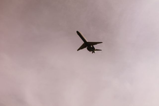 Airplane Flying in Mid Air Under Gray Clouds - Download Free Stock Photos Pikwizard.com