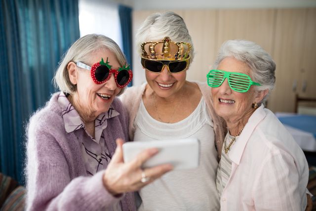 Senior women wearing novelty glasses taking selfie through smart phone - Download Free Stock Photos Pikwizard.com