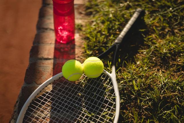 Water bottle, tennis ball and racket on grass - Download Free Stock Photos Pikwizard.com