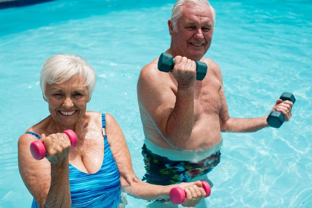 Senior couple exercising with dumbbells in the pool - Download Free Stock Photos Pikwizard.com