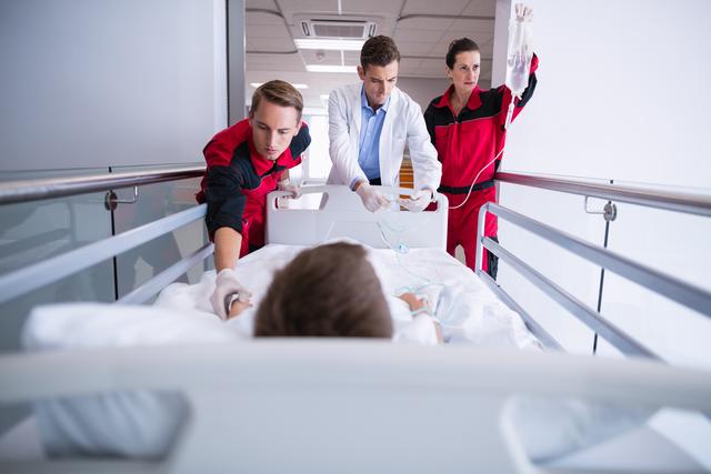 Doctors pushing emergency stretcher bed in corridor - Download Free Stock Photos Pikwizard.com