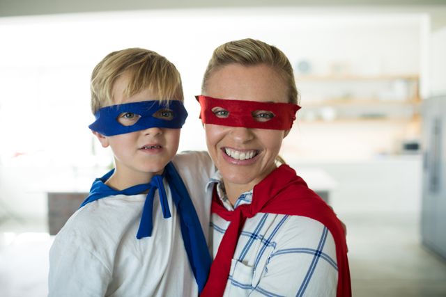 Portrait of mother and son pretending to be superhero in living room - Download Free Stock Photos Pikwizard.com