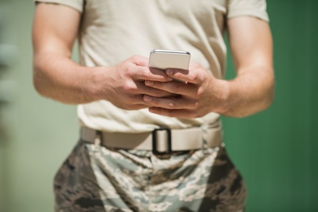 Mid section of military soldier using mobile phone - Download Free Stock Photos Pikwizard.com