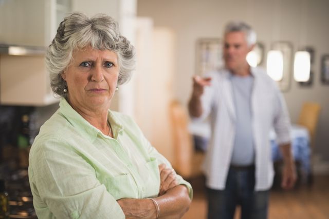 Portrait of unsmiling senior woman with angry man in background - Download Free Stock Photos Pikwizard.com