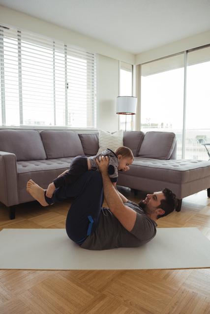 Father playing with his baby in living room - Download Free Stock Photos Pikwizard.com