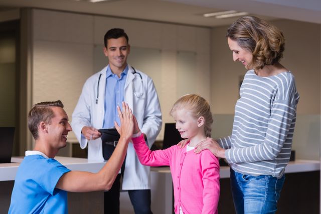 Doctor giving high five to girl - Download Free Stock Photos Pikwizard.com