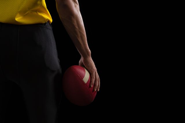 American football player holding a ball  - Download Free Stock Photos Pikwizard.com
