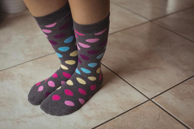Womans feet wearing multicolored polka dots socks - Download Free Stock Photos Pikwizard.com