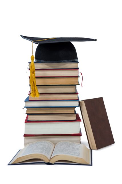 Mortarboard on stack of books - Download Free Stock Photos Pikwizard.com