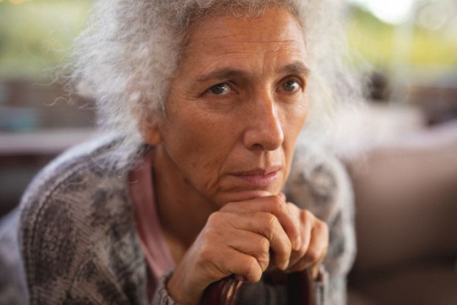 Portrait of thoughtful caucasian woman leaning on cane - Download Free Stock Photos Pikwizard.com