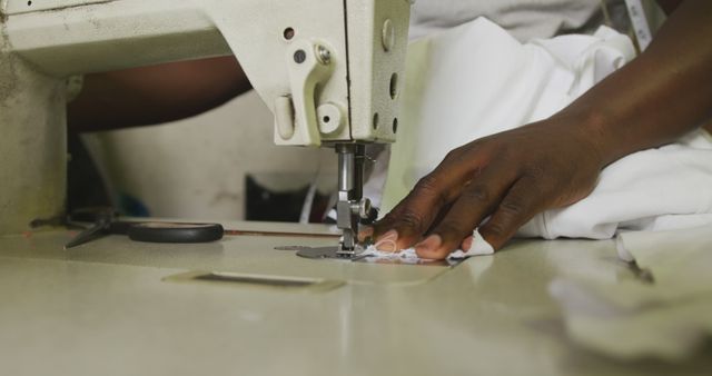 Hand of african american male tailor using sewing machine in workshop - Download Free Stock Photos Pikwizard.com