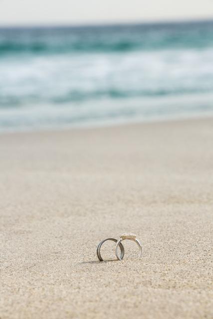 Wedding rings on sand - Download Free Stock Photos Pikwizard.com
