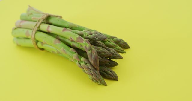Image of close up of bundle of fresh asparagus over green background - Download Free Stock Photos Pikwizard.com