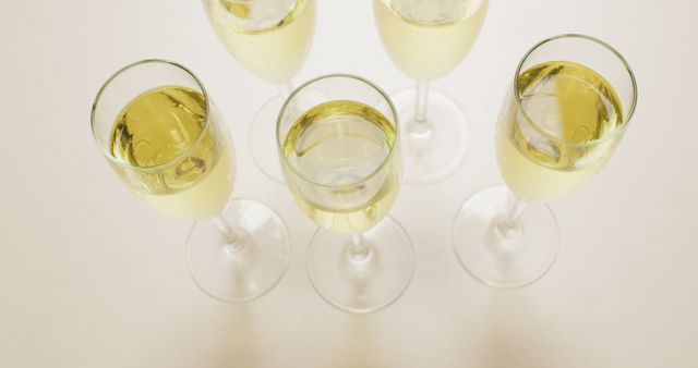 Image of champagne in glasses on beige background. alcohol, beverage, drinks, party and celebration concept.